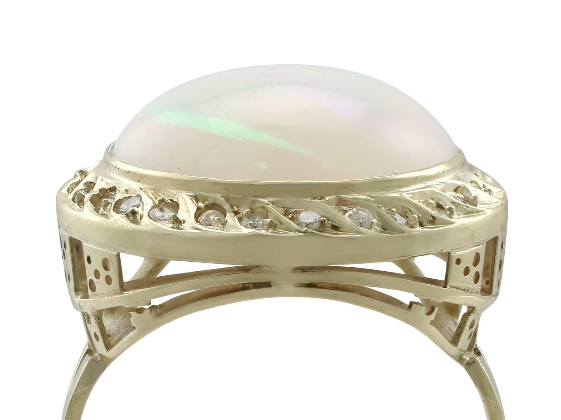 A stunning vintage 4.35 carat opal and 0.27 carat diamond, 14 karat yellow gold cocktail ring; part of our diverse vintage jewelry and estate jewelry collections

This stunning, fine and impressive vintage opal ring with diamond has been crafted in