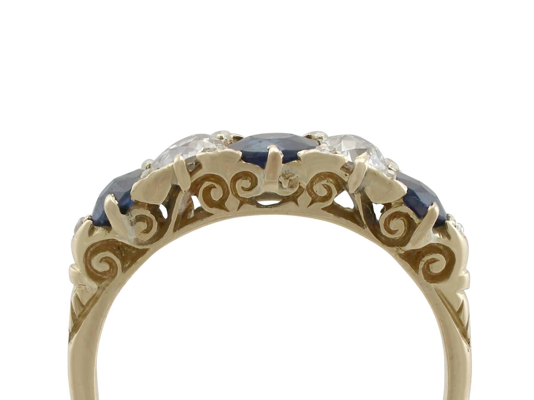 An impressive 0.68 carat blue sapphire and 0.43 carat diamond, 18 karat yellow gold five stone cocktail ring; part of our diverse antique jewelry and estate jewelry collections

This fine and impressive antique diamond ring has been crafted in 18 k