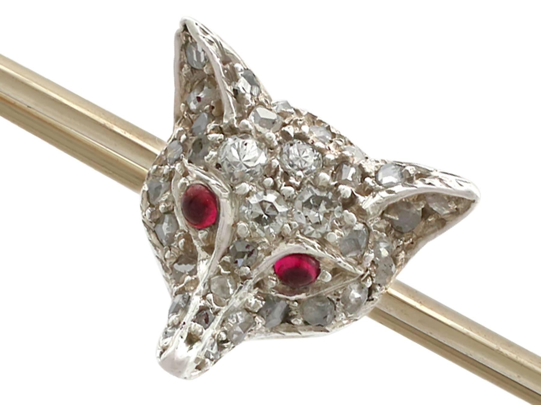 An impressive Victorian 0.28 carat diamond and 0.04 carat ruby, 9 karat yellow gold and silver set 'fox' bar brooch; part of our diverse antique jewelry collections

This fine and impressive antique Victorian brooch has been crafted in 9k yellow