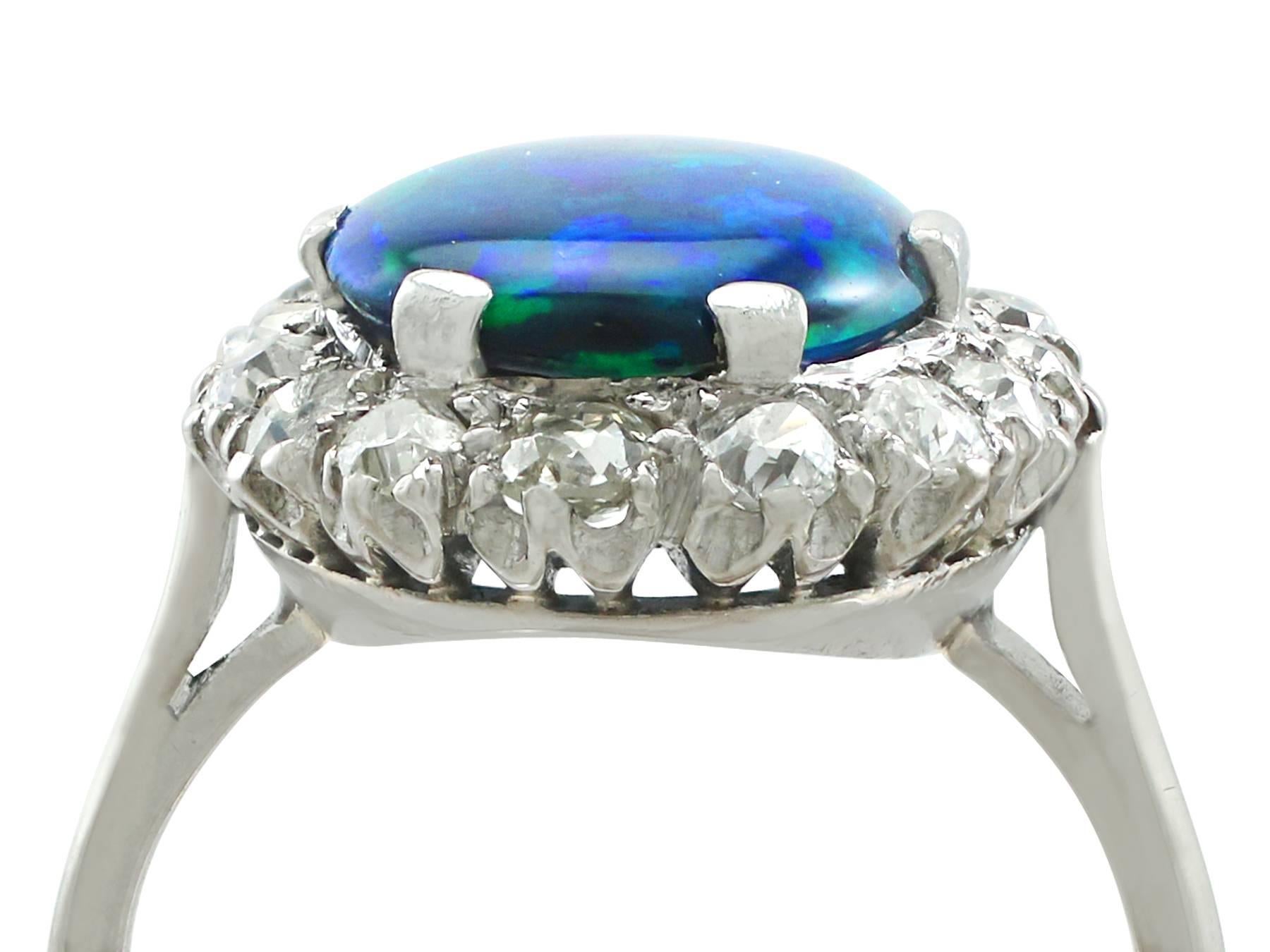 A stunning antique 1930's 1.89 carat black opal and 0.78 carat diamond, platinum cluster style dress ring; part of our diverse gemstone jewelry collections

This stunning, fine and impressive antique black opal ring has been crafted in