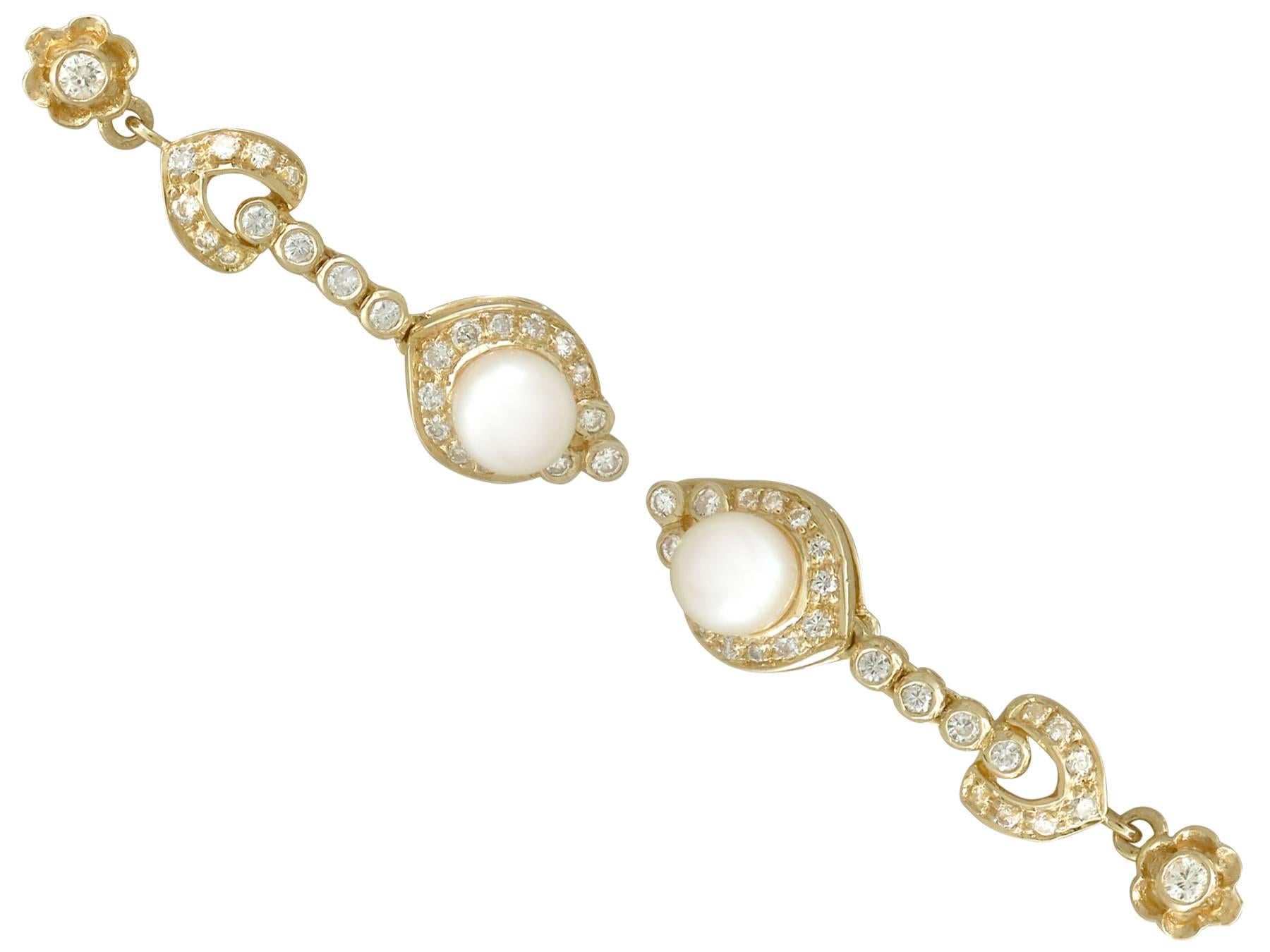 An impressive pair of vintage European 0.63 carat diamond and cultured pearl, 18 karat yellow gold drop earrings; part of our diverse pearl jewelry collections

These fine and impressive pearl and diamond earrings have been crafted in 18k yellow