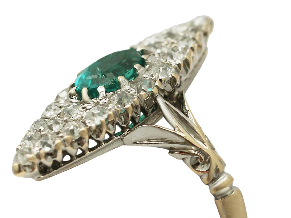 A stunning, fine and impressive antique 0.63 carat natural emerald and 0.92 carat diamond, 18 karat yellow gold, 18 karat white gold set marquise ring; part of our antique jewelry/estate jewelry collections

This stunning antique emerald and