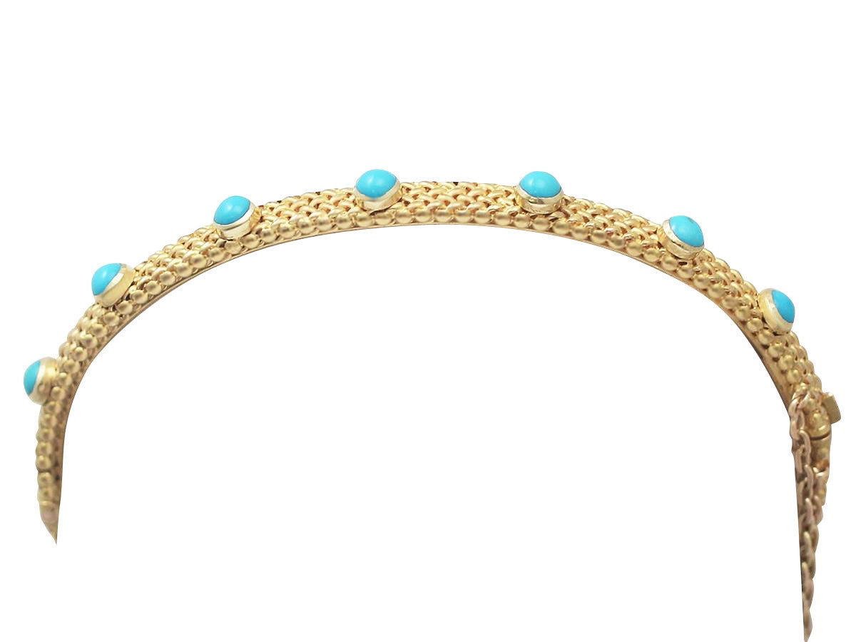 A fine and impressive Victorian turquoise and 18 karat yellow gold bangle with a 15 karat yellow gold catch; part of our antique jewelry and estate jewelry collections

This impressive antique turquoise bracelet has been crafted in 18k yellow gold