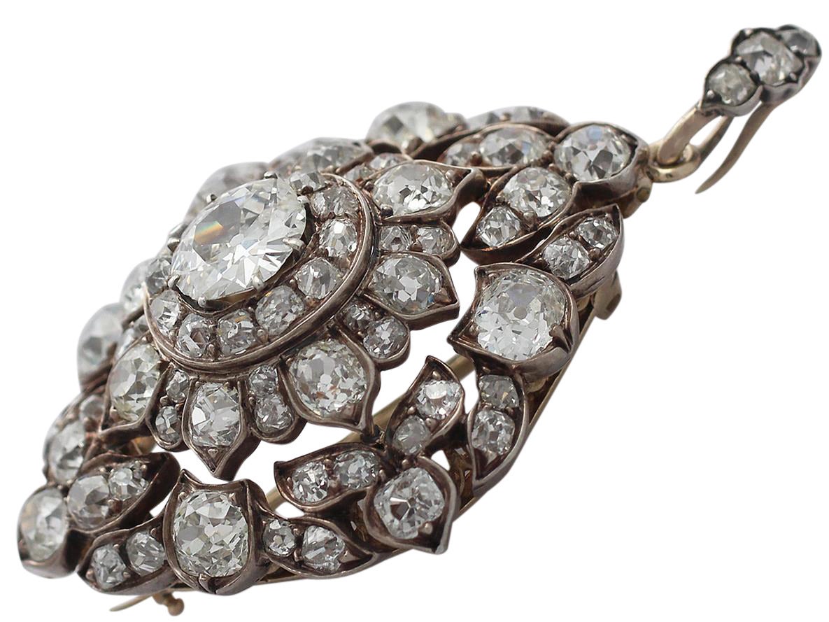 An exceptional, fine and impressive antique Victorian English 15 karat yellow gold, silver set diamond pendant/brooch; part of our diverse antique jewelry.

This fine and versatile diamond brooch/pendant has a rhomboid, cushion shaped form.

The