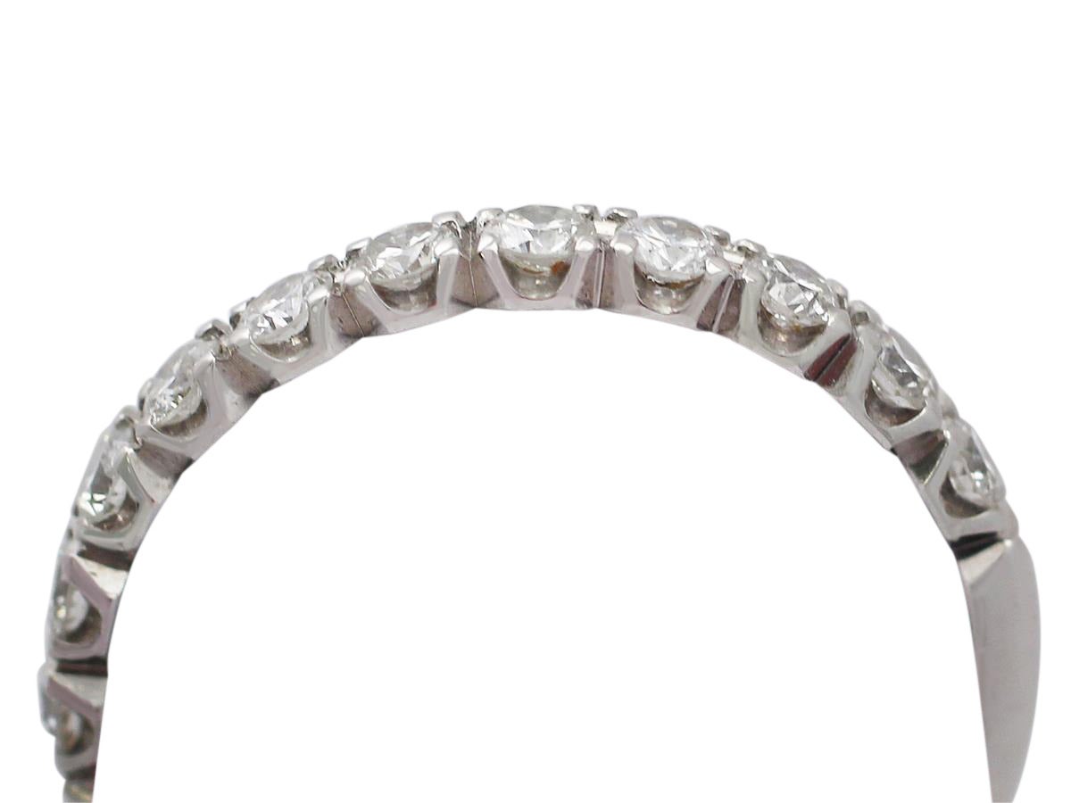 A fine and impressive vintage 1.02 carat diamond, 14 karat white gold eternity ring; part of our vintage jewelry/estate jewelry collections

This impressive 1960s ring has been crafted in 14k white gold.

This low profile, vintage ring is set with
