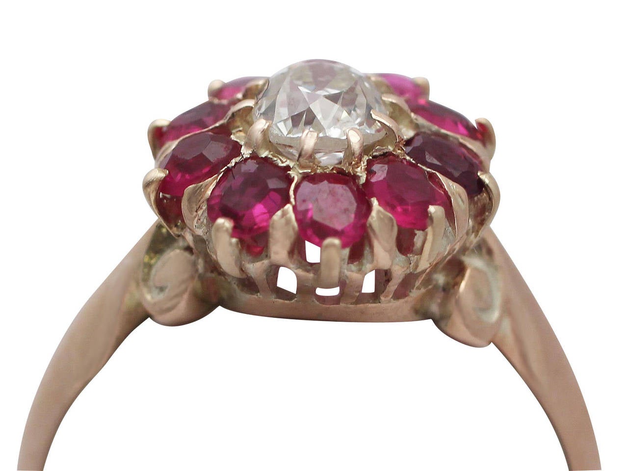 A fine and impressive antique 0.60 carat natural ruby and 0.38 carat diamond, 9 karat rose gold dress ring; part of our antique jewelry and estate jewelry collections

This impressive ruby and diamond cluster ring has been crafted in 9k rose