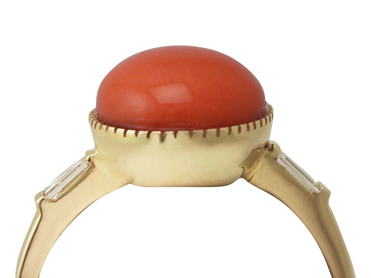 A fine and impressive vintage red coral and 0.12 carat diamond and 18 karat yellow gold ring; part of our diverse vintage jewelry and estate jewelry collections

This impressive coral and diamond ring has been crafted in 18k yellow gold.

The ring