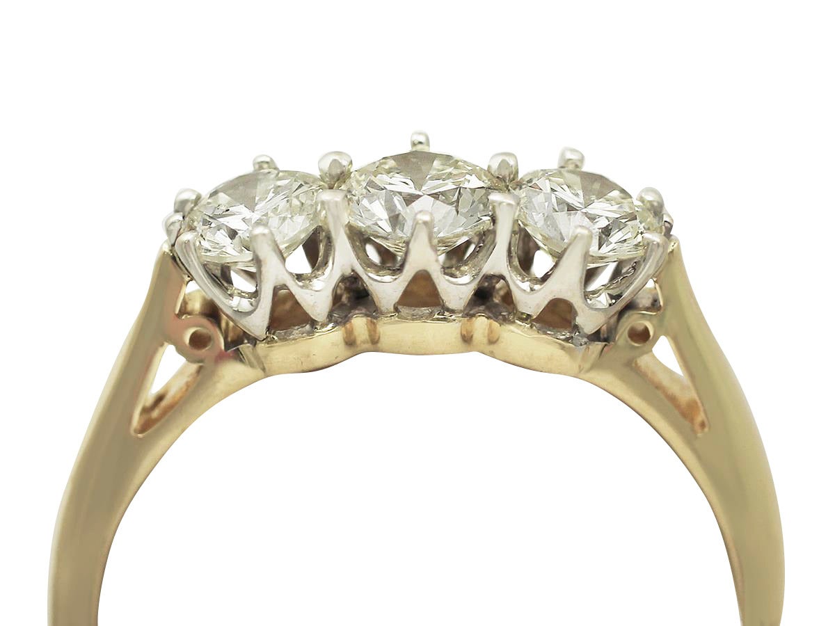 A fine and impressive vintage 18 karat yellow gold and 18 karat white gold set 1 carat diamond trilogy ring; part of our diverse vintage three-stone ring collection

This impressive 1 carat diamond trilogy ring has been crafted in 18 karat yellow