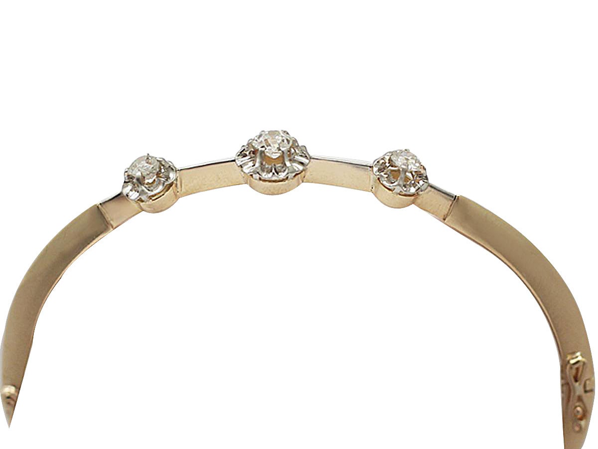 A fine and impressive antique Victorian 0.75 carat diamond and 18 karat yellow gold, platinum set bangle; part of our antique jewelry and estate jewelry collections

This impressive antique 18k gold, diamond bangle has been crafted in 18k yellow