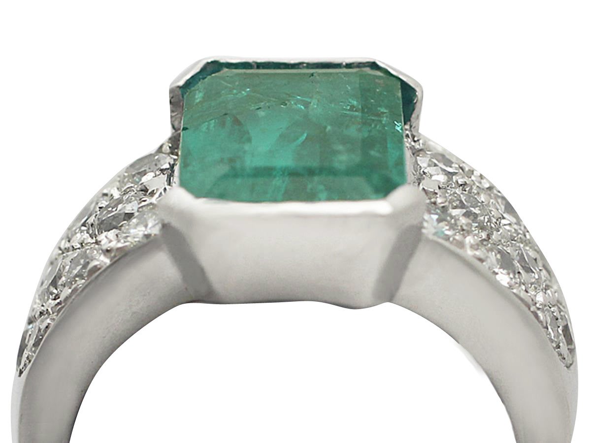 A fine and impressive vintage French 1.05 carat natural emerald and 1.05 carat diamond, 18 karat white gold dress ring; part of our diverse vintage jewelry and estate jewelry collections

This impressive French emerald and diamond ring has been