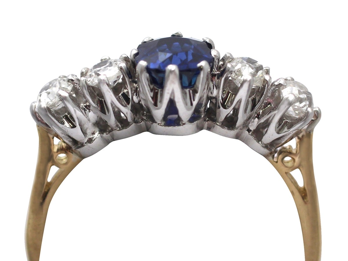 A stunning, fine and impressive antique 1.19 carat natural blue sapphire and antique 1.19 carat (total) diamond, 18 karat yellow gold contemporary ring; an addition to our diamond and gemstone jewelry and estate jewelry collections

This stunning