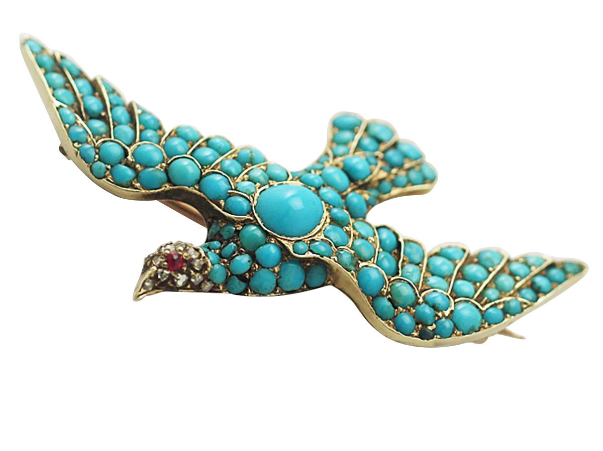 A fine impressive antique Victorian turquoise, ruby and 0.15 carat diamond, 14 karat yellow gold, brooch modelled in the form of a dove; part of our diverse antique jewelry and estate jewelry collections.

This fine antique turquoise brooch has