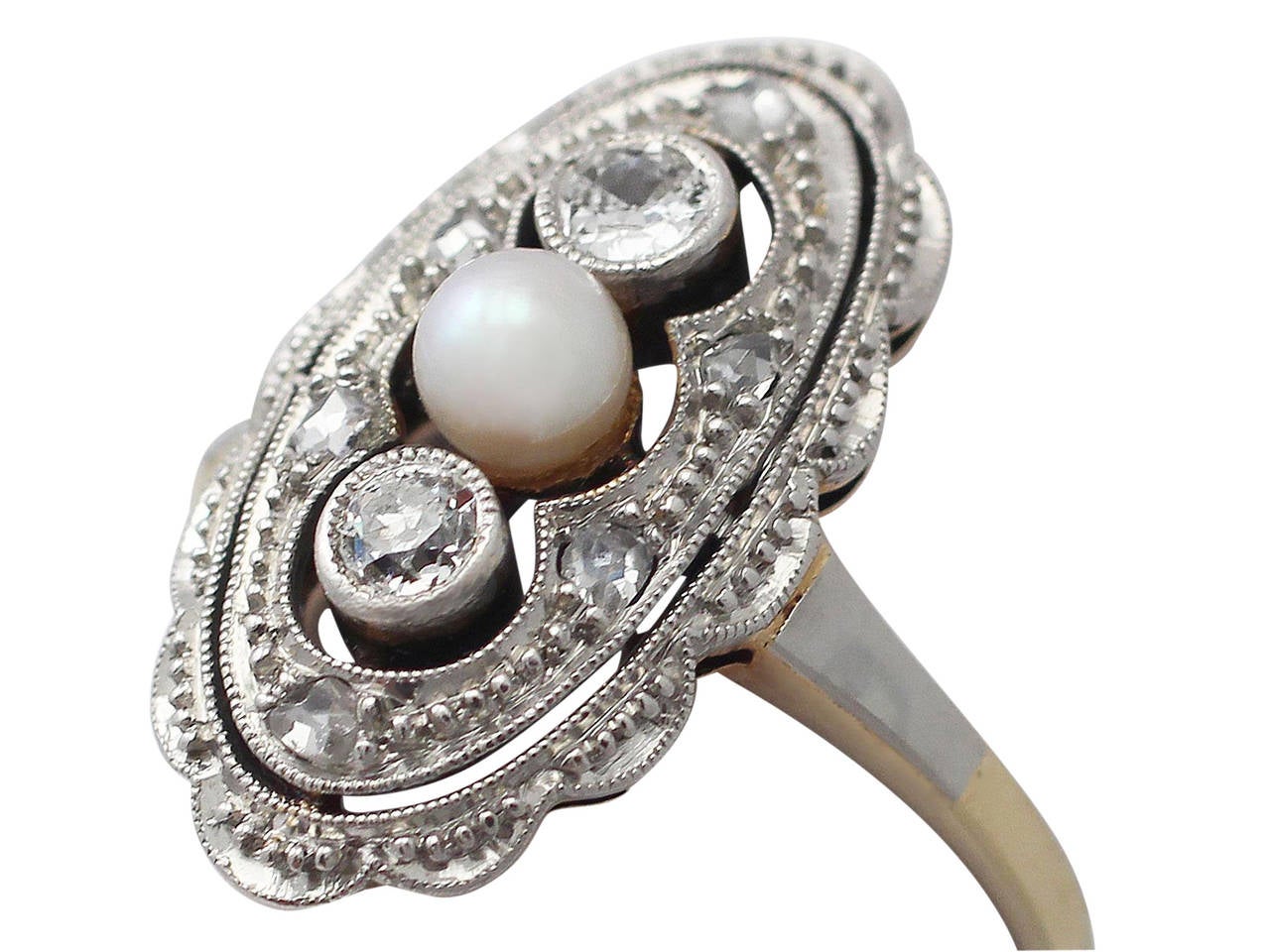 A fine and impressive antique 0.25 carat diamond and seed pearl, 14 karat yellow gold, 14k white gold set dress ring; part our antique jewelry and estate jewelry collections

This fine antique diamond and pearl ring has been crafted in 14k yellow