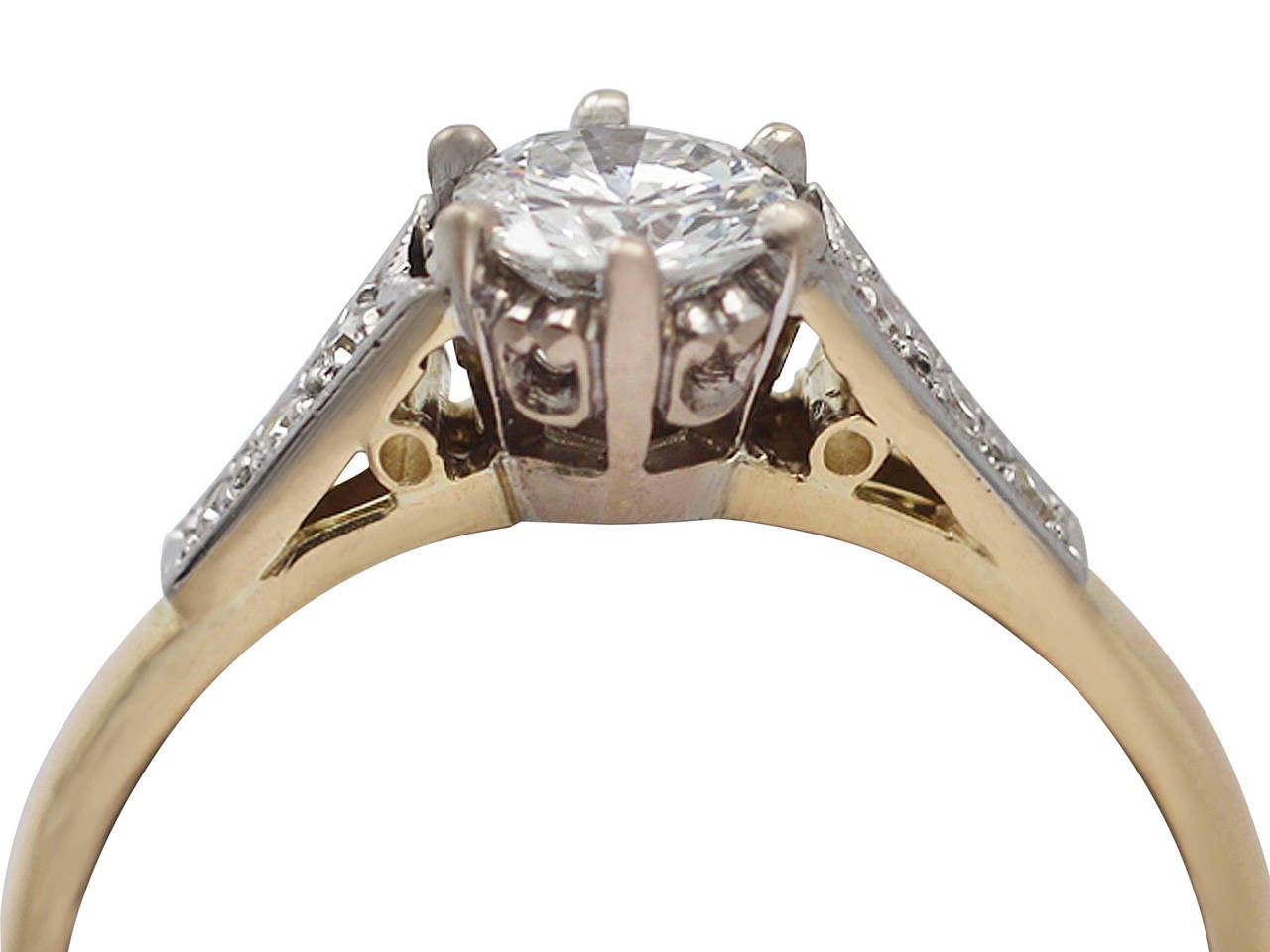 A fine and impressive vintage 0.70 carat diamond (total) and 18 karat yellow gold, platinum set solitaire ring; part our diamond jewelry and estate jewelry collections

This impressive vintage diamond solitaire ring has been crafted in 18k yellow