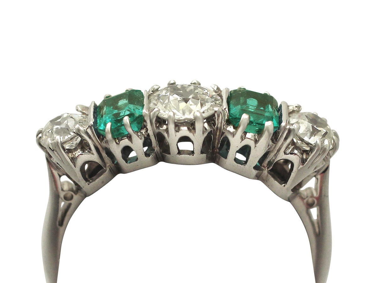 A fine and impressive 1.18 carat diamond, 0.72 carat emerald, 18 karat white gold dress ring; part of our antique, vintage jewellery and estate jewelry collections

This fine antique emerald and diamond dress ring has been crafted in 18k white