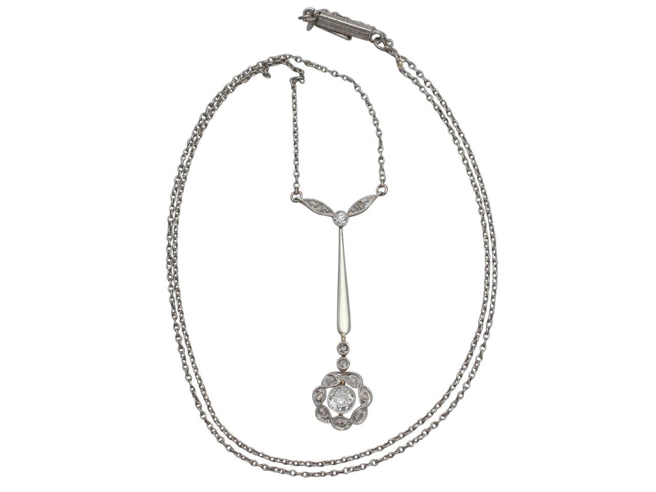A fine and impressive antique 0.57 carat diamond and 18 karat yellow gold, 18 karat white gold set pendant with an integrated white gold chain; part of our antique jewellery and estate jewelry collections.

This impressive antique diamond pendant