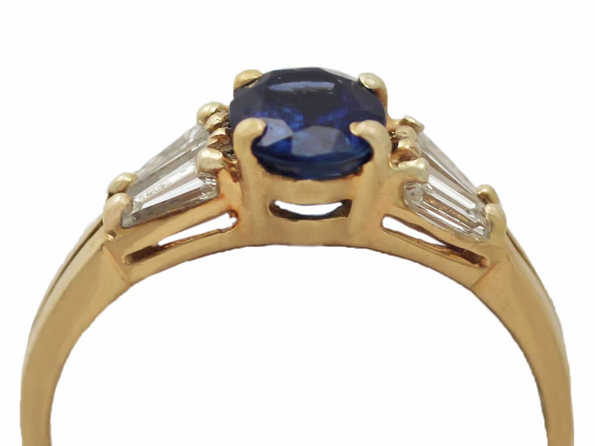 A fine and impressive vintage 1.16 carat natural blue sapphire and 0.46 carat diamond, 18 karat yellow gold ring; part of our vintage jewelry and estate jewelry collections

This fine vintage sapphire ring has been crafted in 18k yellow