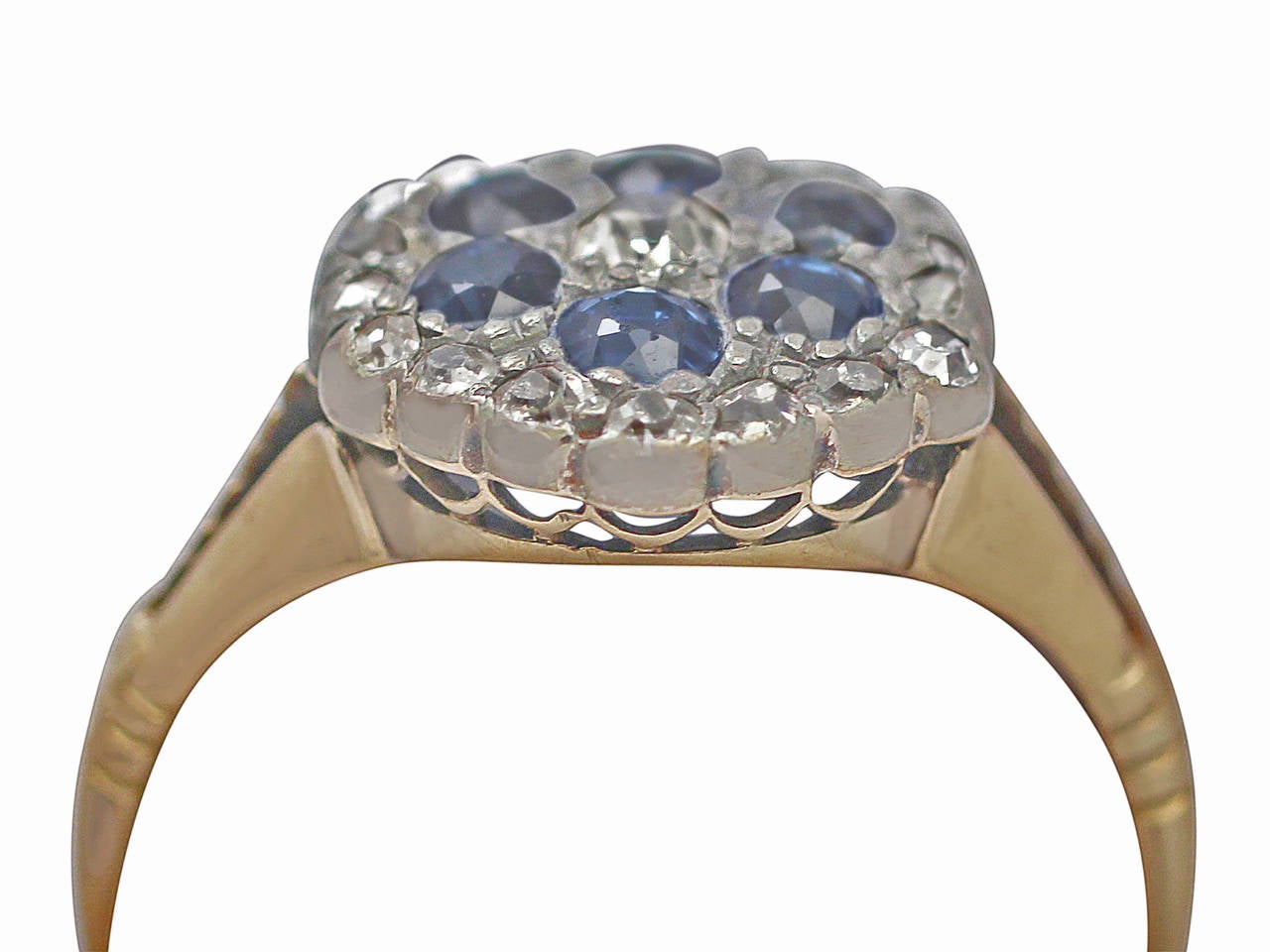 A fine antique 0.58 carat blue sapphire and 0.52 carat diamond, 18 karat yellow gold, platinum set cluster ring; part our antique jewelry and estate jewelry collections

This fine antique sapphire and diamond ring has been crafted in 18k yellow gold