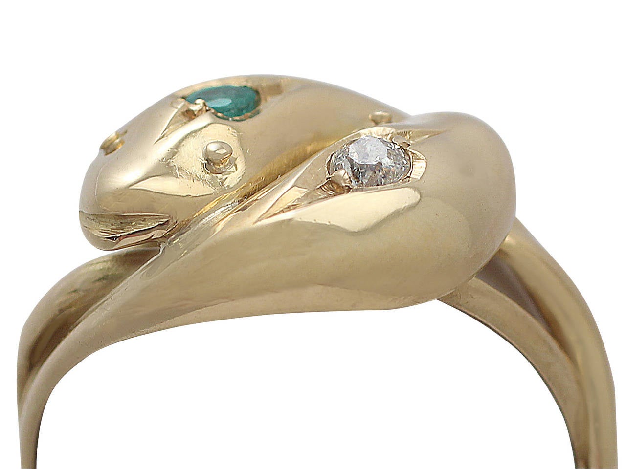 A fine and impressive unusual English antique 0.05 carat natural emerald and 0.05 carat diamond, 18 karat yellow gold snake ring; part of our diverse antique jewelry and estate jewelry collections

This dress ring has been crafted in 18k yellow