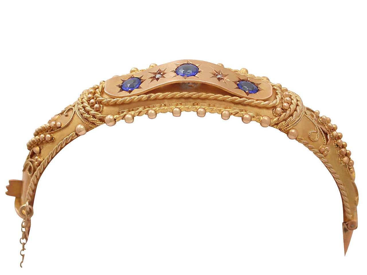 An impressive George V garnet doublet and diamond, 9 karat yellow and rose gold bangle; part of our antique jewelry and estate jewelry collections

This impressive antique garnet bangle has been crafted in 9 karat yellow and rose gold.

The hinged