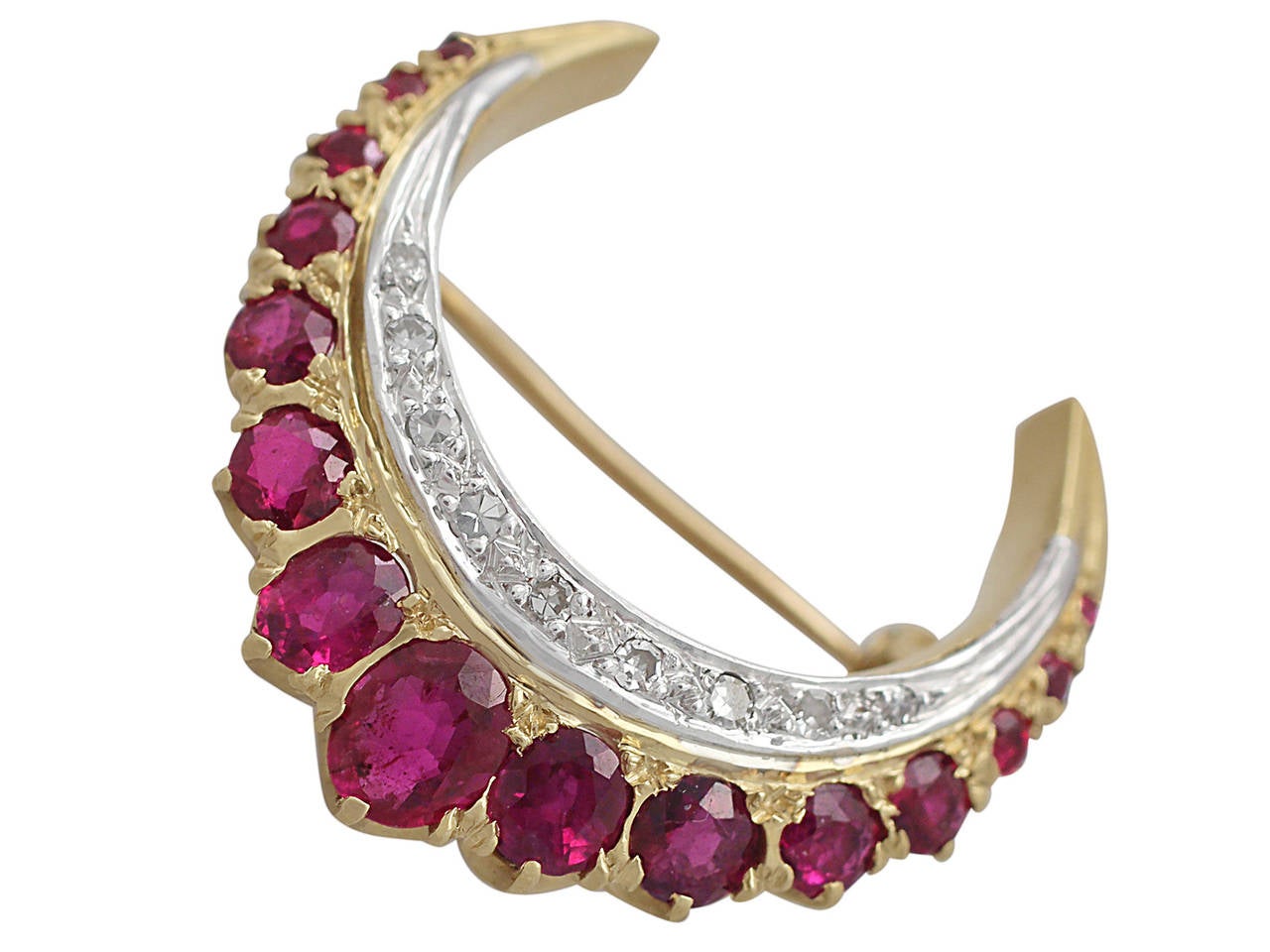 A fine and impressive 2.32 carat ruby and 0.52 carat diamond, 18 karat yellow gold, 18k white gold set crescent style brooch; part of our jewelry and estate jewelry collections

This impressive brooch has been crafted in 18k yellow with 18k white