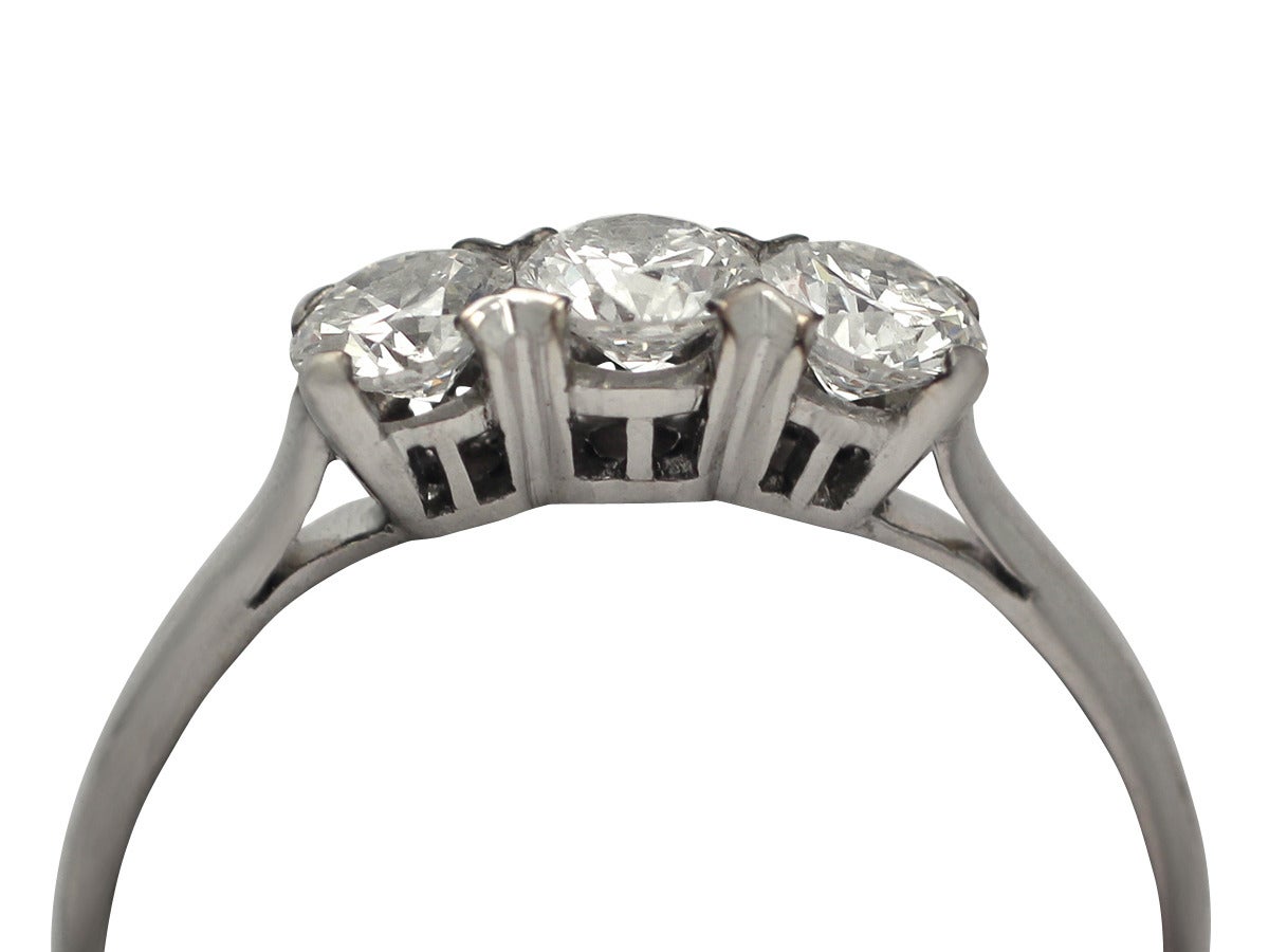 A very good 0.69 carat diamond and 14 karat white gold three stone ring; part of our vintage trilogy ring collection

This vintage trilogy ring has been crafted in 14k white gold.

The pierced decorated mount displays three evenly color matched,