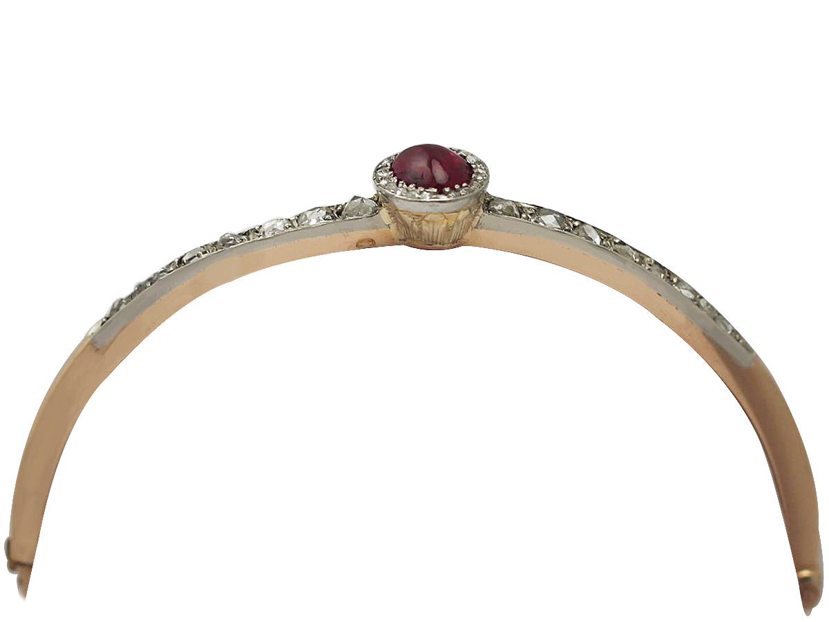 A fine and impressive antique 0.95 carat natural ruby and 0.81 carat diamond, 18 carat rose gold, silver set bangle; part of our ruby bangle collection

This impressive antique ruby bangle has been crafted in 18 carat rose gold with a silver