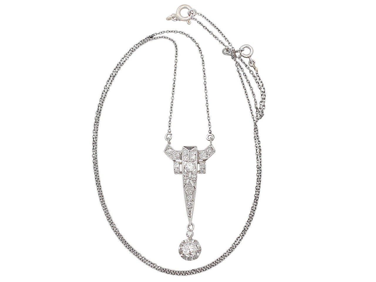 A fine vintage 0.44 carat diamond and platinum, Art Deco style pendant; part of our vintage jewelry and estate jewelry collections

This fine vintage diamond pendant has been crafted in platinum.

The pierced decorated frame has an iconic angular