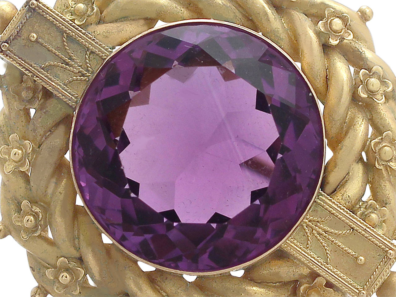 A fine and impressive antique Victorian 18.91 carat natural amethyst and 20 karat yellow gold brooch; part of our antique jewelry and estate jewelry collections

This impressive antique Victorian amethyst brooch has been crafted in 20k yellow