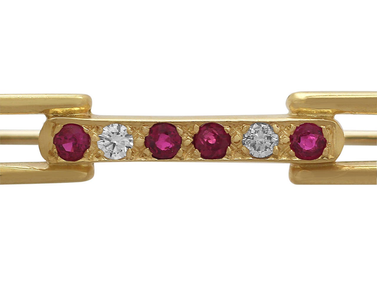 An Art Deco style 18 karat yellow gold, 0.12 carat ruby and 0.04 carat diamond brooch; part of our vintage jewelry and estate jewelry collections.

This vintage Art Deco brooch has been crafted in 18k yellow gold.

The central bar of the