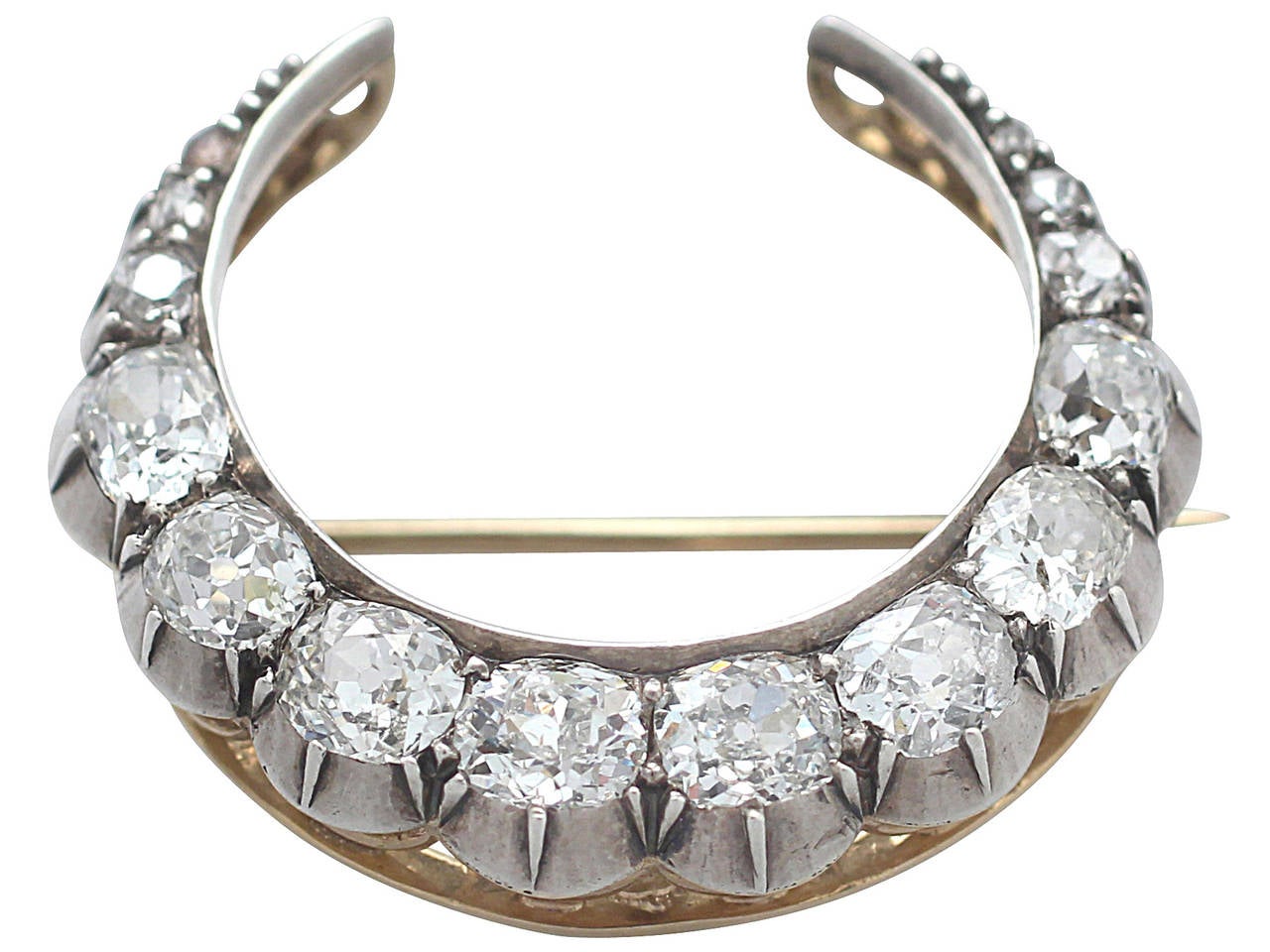 A stunning fine and impressive antique 2.89 carat diamond and 15 karat yellow gold, silver set crescent brooch; part of our diverse antique jewelry and estate jewelry collections

This stunning antique Victorian diamond crescent brooch has been