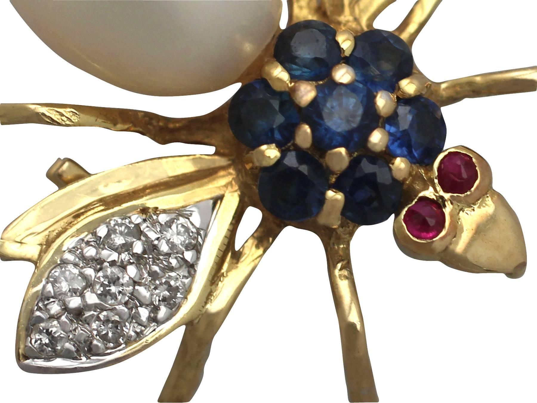 A fine and impressive vintage 0.14 carat diamond, pearl, sapphire and ruby, 18 karat yellow gold and 18 karat white gold set brooch in the form of a winged insect; part of our vintage jewelry and estate jewelry collections

This fine and