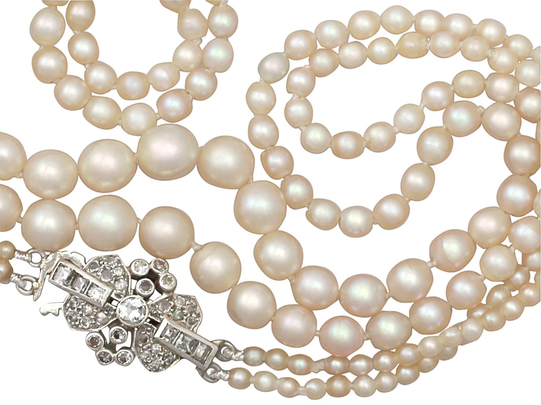 A stunning, fine and impressive double strand pearl necklace with a 0.55 carat diamond, 9 karat white gold and 18 karat white gold, platinum set clasp; part of our diverse necklace and pendant collection

This stunning, fine and impressive choker