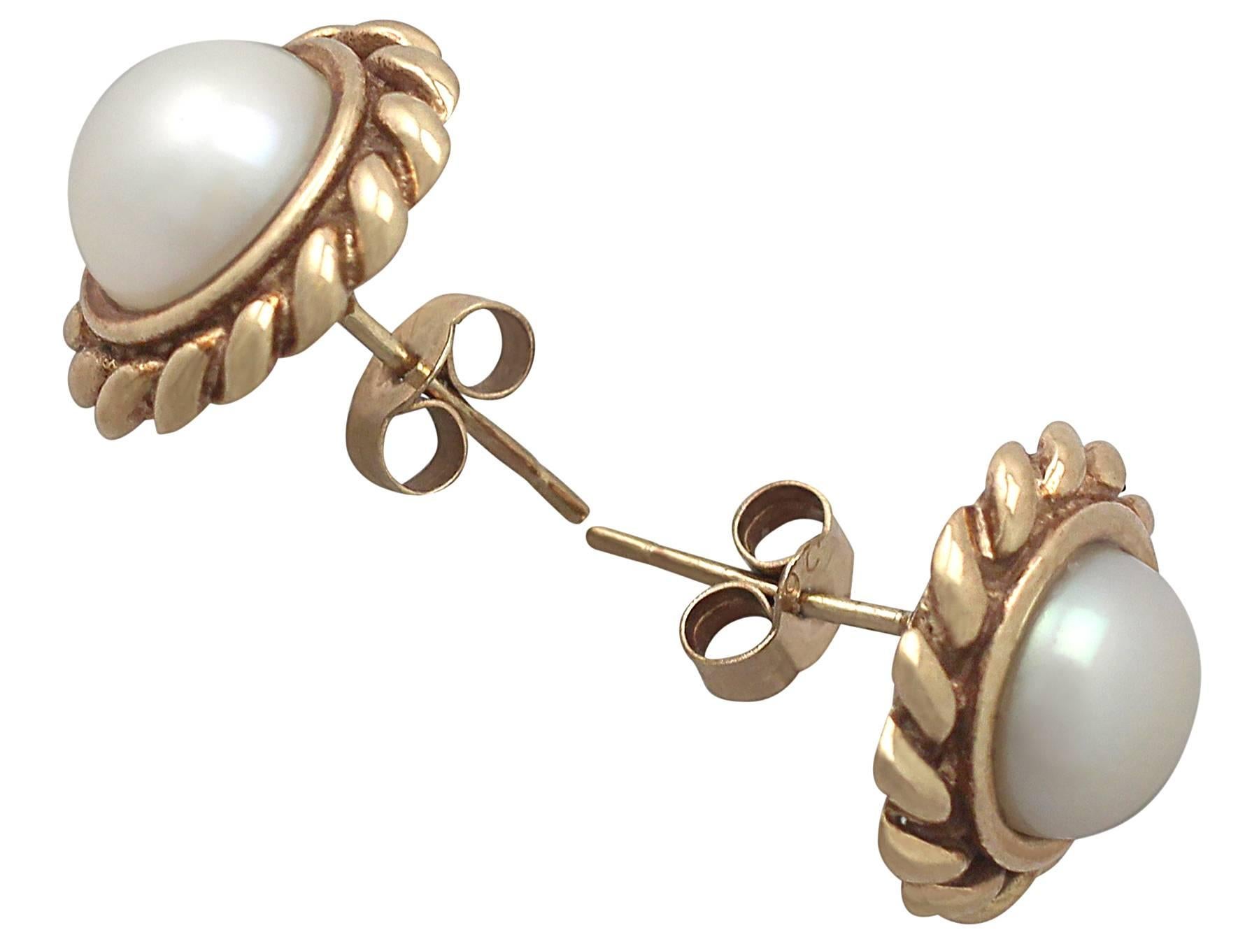 A fine and impressive pair of large vintage pearl and 9 karat yellow gold stud earrings; part of our vintage jewelry and estate jewelry collections

This fine and impressive pair of large pearl stud earrings have been crafted in 9k yellow