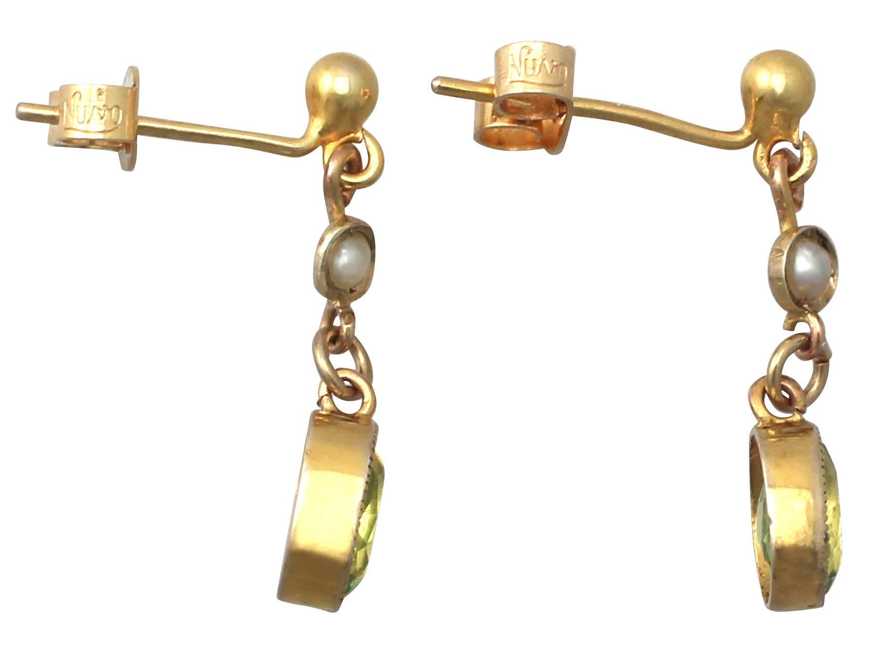 A fine and impressive pair of antique 1.22 carat natural peridot and pearl, 9 karat yellow gold drop earrings; part of our antique jewelry and estate jewelry collections

This fine and impressive antique peridot earrings have been crafted in 9k