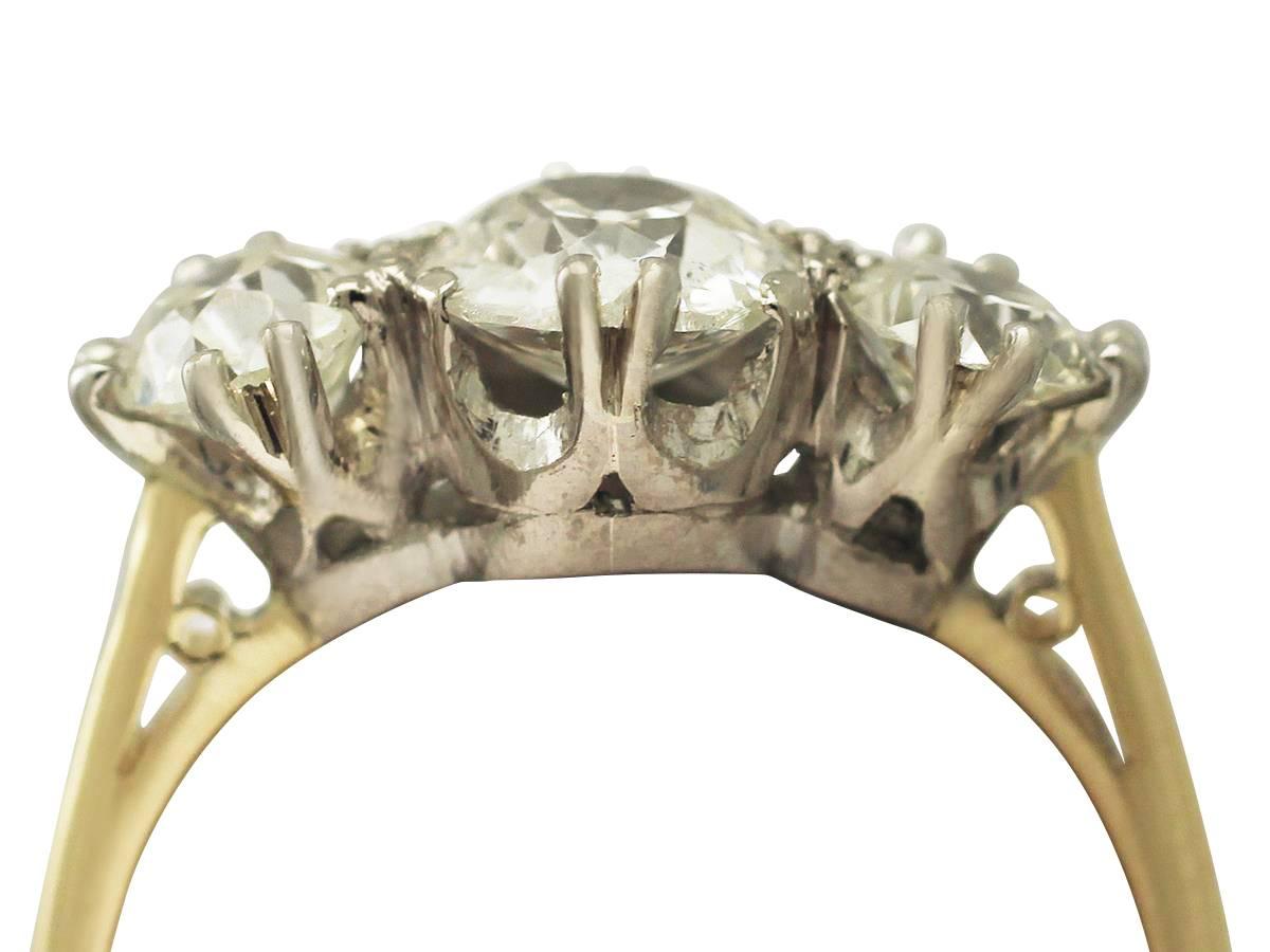 A stunning, fine and impressive antique and vintage 1.83 carat diamond three stone ring in 18 karat yellow gold with an 18 karat white gold setting; part of our diverse diamond jewelry and estate jewelry collections

This stunning diamond three