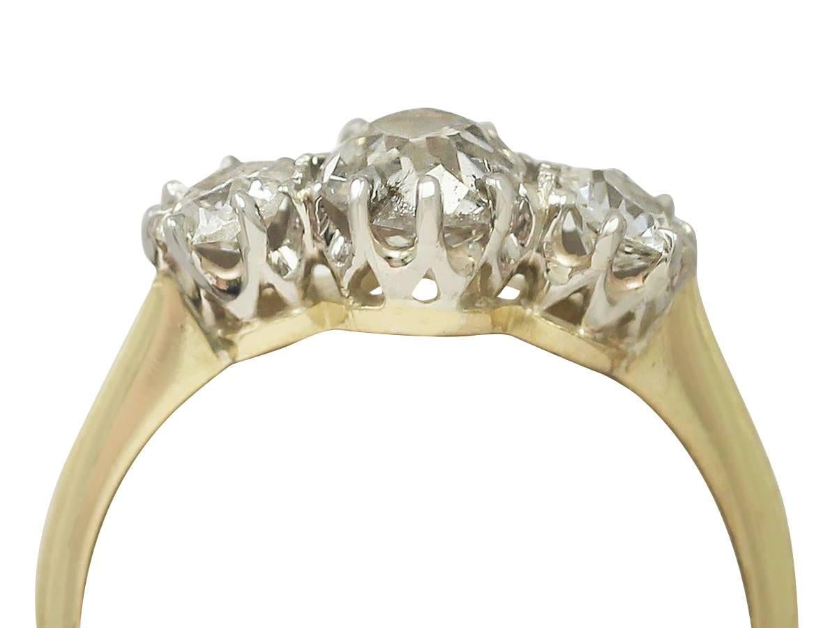 A fine and impressive antique 1.29 carat diamond and 18 karat yellow gold, platinum set three stone/trilogy ring; part of our diverse antique three-stone ring collection

This impressive old European cut diamond ring has been crafted in 18k yellow