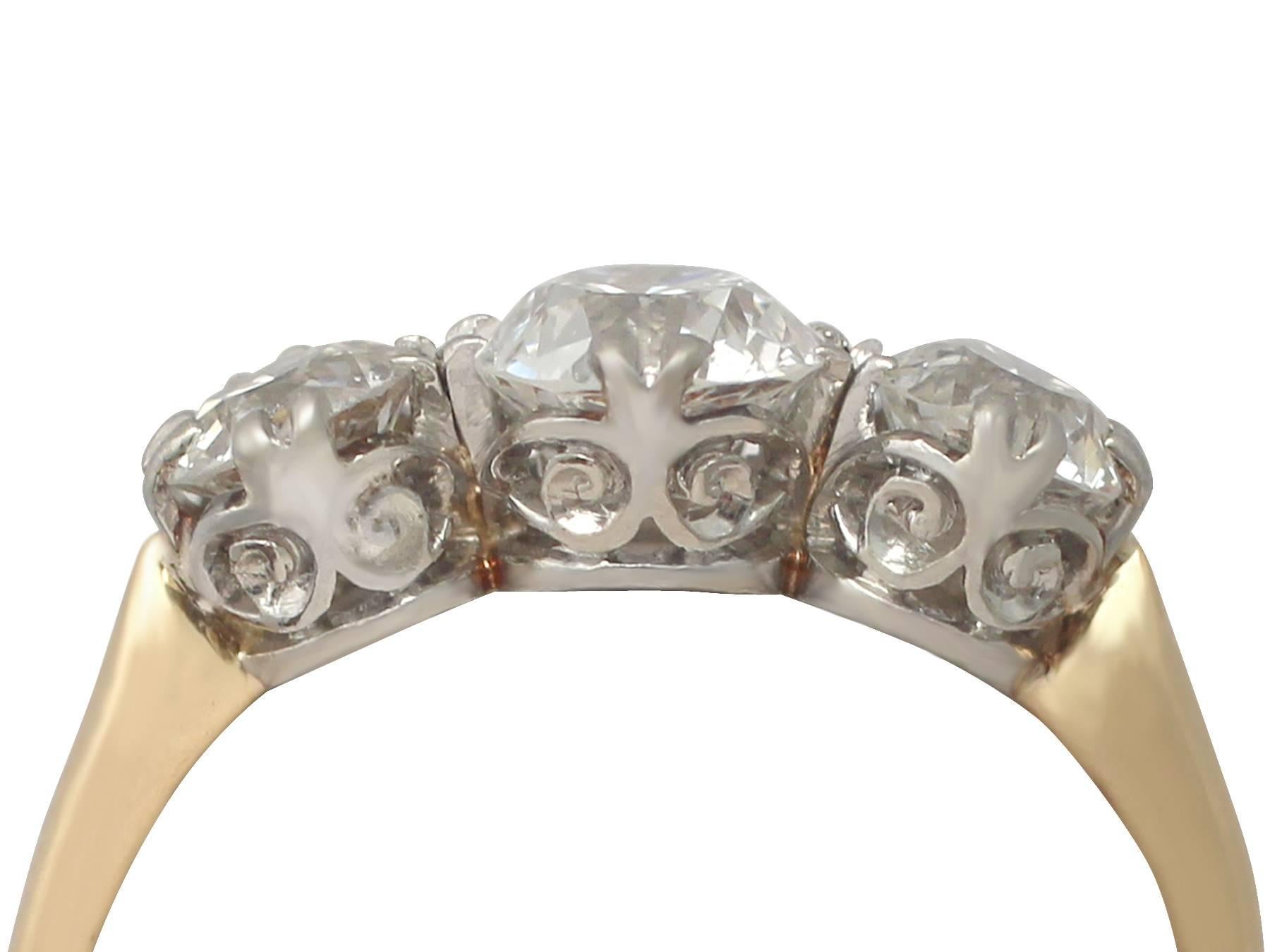 A fine and impressive vintage 1.74 carat diamond (total), 18 karat yellow gold, 18 karat white gold set trilogy ring; part of our diverse antique jewelry and estate jewelry collections

This fine and impressive vintage diamond trilogy ring has