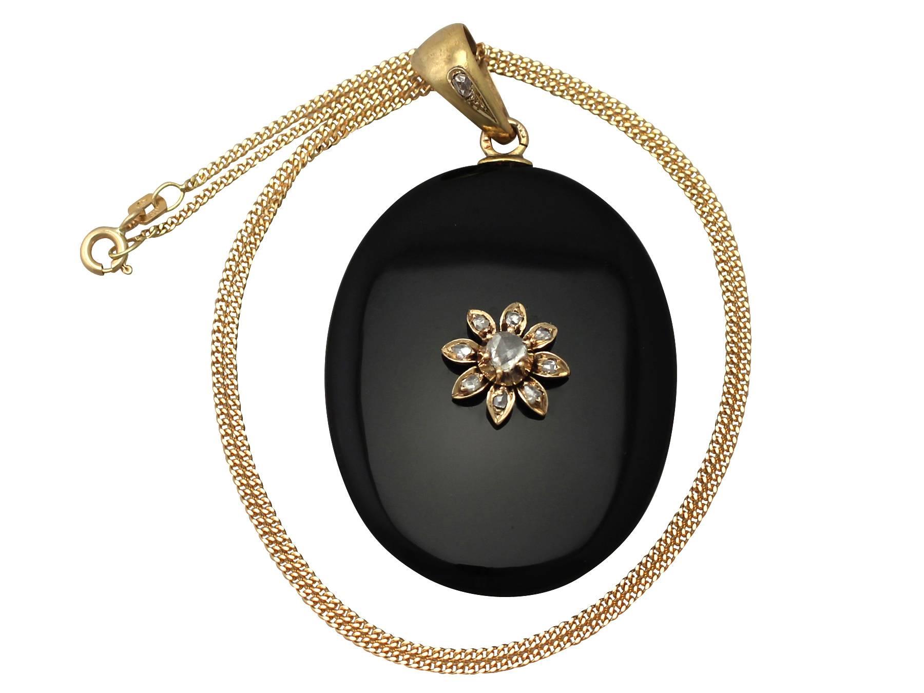A fine and impressive antique Victorian onyx and 0.49 carat diamond, 14 karat yellow gold pendant /locket; part of our antique jewelry and estate jewelry collections

This substantial antique Victorian pendant has been crafted in onyx.

The anterior
