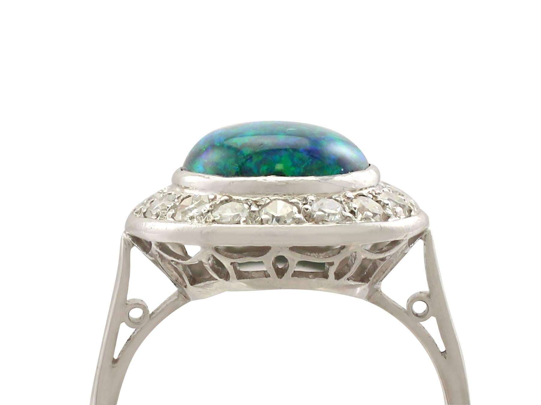 A stunning antique 1.30 carat black opal and 0.28 carat diamond, platinum cluster style dress ring; part of our diverse antique jewellery and estate jewelry collections.

This stunning, fine and impressive opal and diamond cluster ring has been