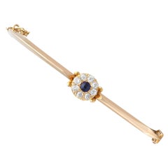 Antique 0.18 Carat Sapphire 0.40 Carat Diamond 15k Yellow Gold Bangle Circa 1900