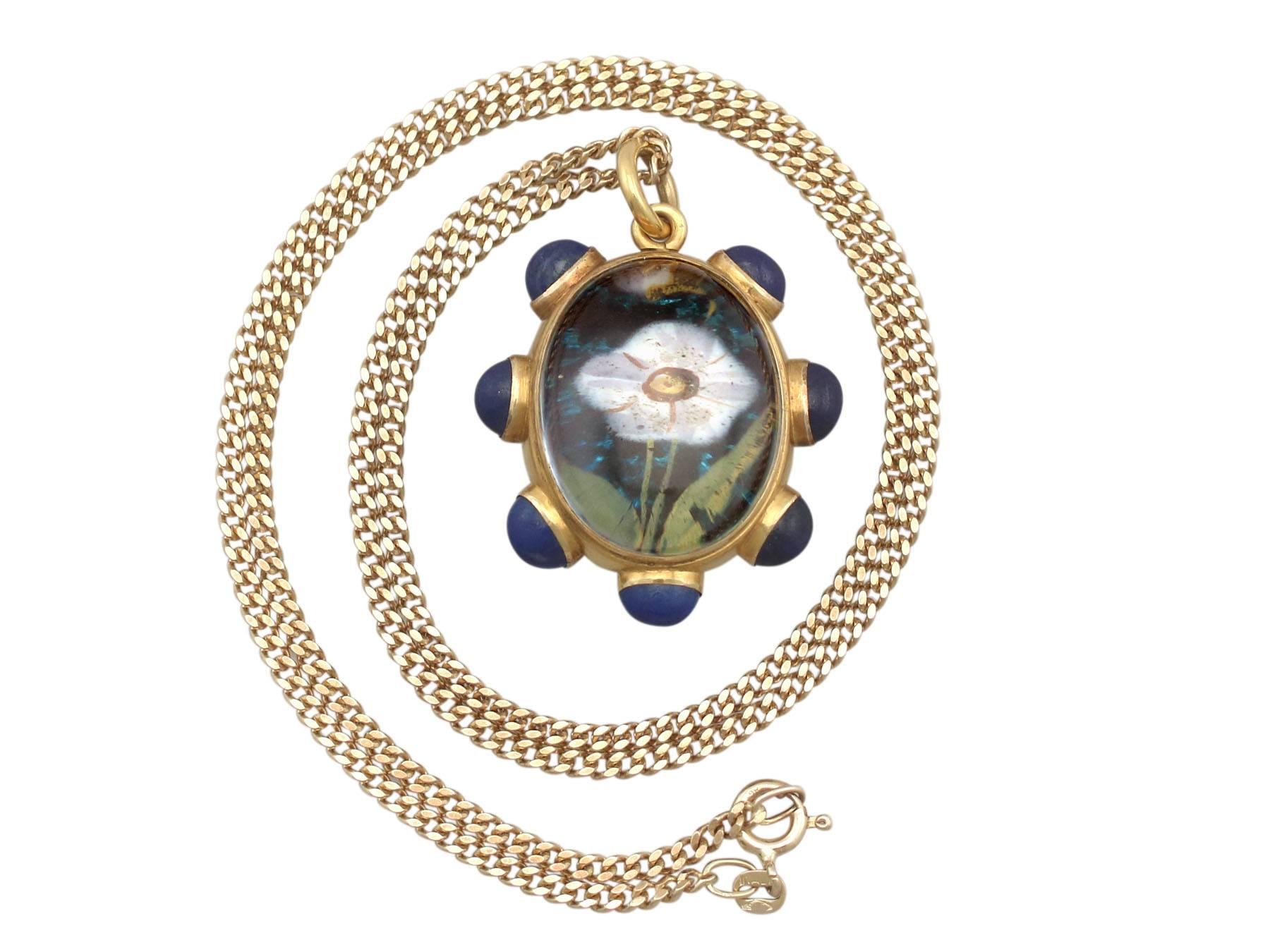 A stunning and exceptional rock crystal, lapis lazuli and 18k yellow gold locket / pendant by Garrard & Co; part of our diverse antique jewellery collections.

This stunning, exceptional, fine and impressive rock crystal pendant has been crafted in