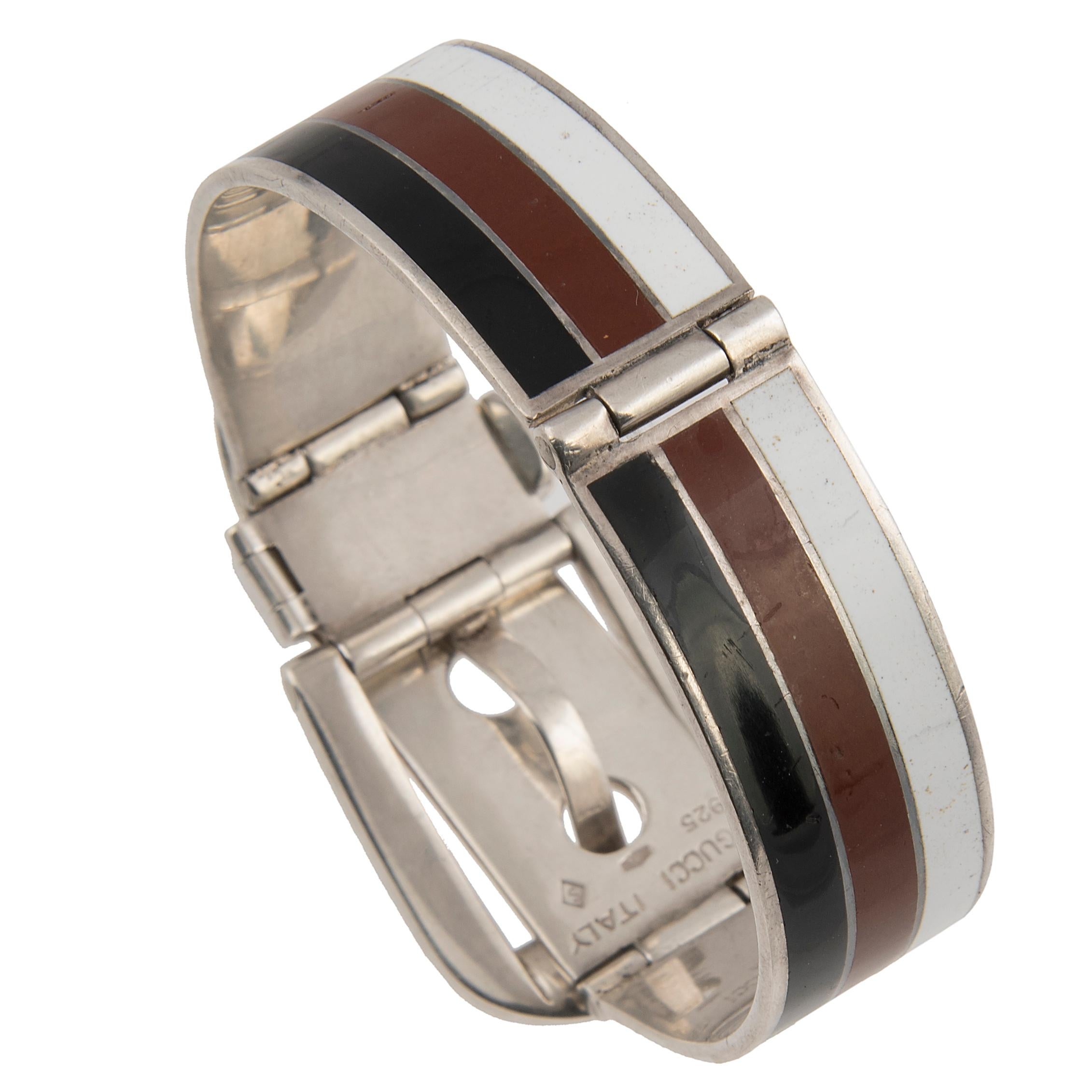 The timeless Garden Cuff Bracelet was first developed by Gucci in the 1950s. Designed as a sterling silver cuff bracelet with buckle closure, featuring white, brown and black enamel stripes.
Signed Gucci Italy and with Italian hallmarks
Size: 16.5 -