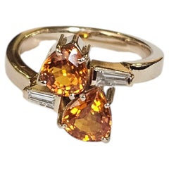 Set in 18K Gold, Orange Sapphire & Tapered Baguette Diamond Engagement Ring