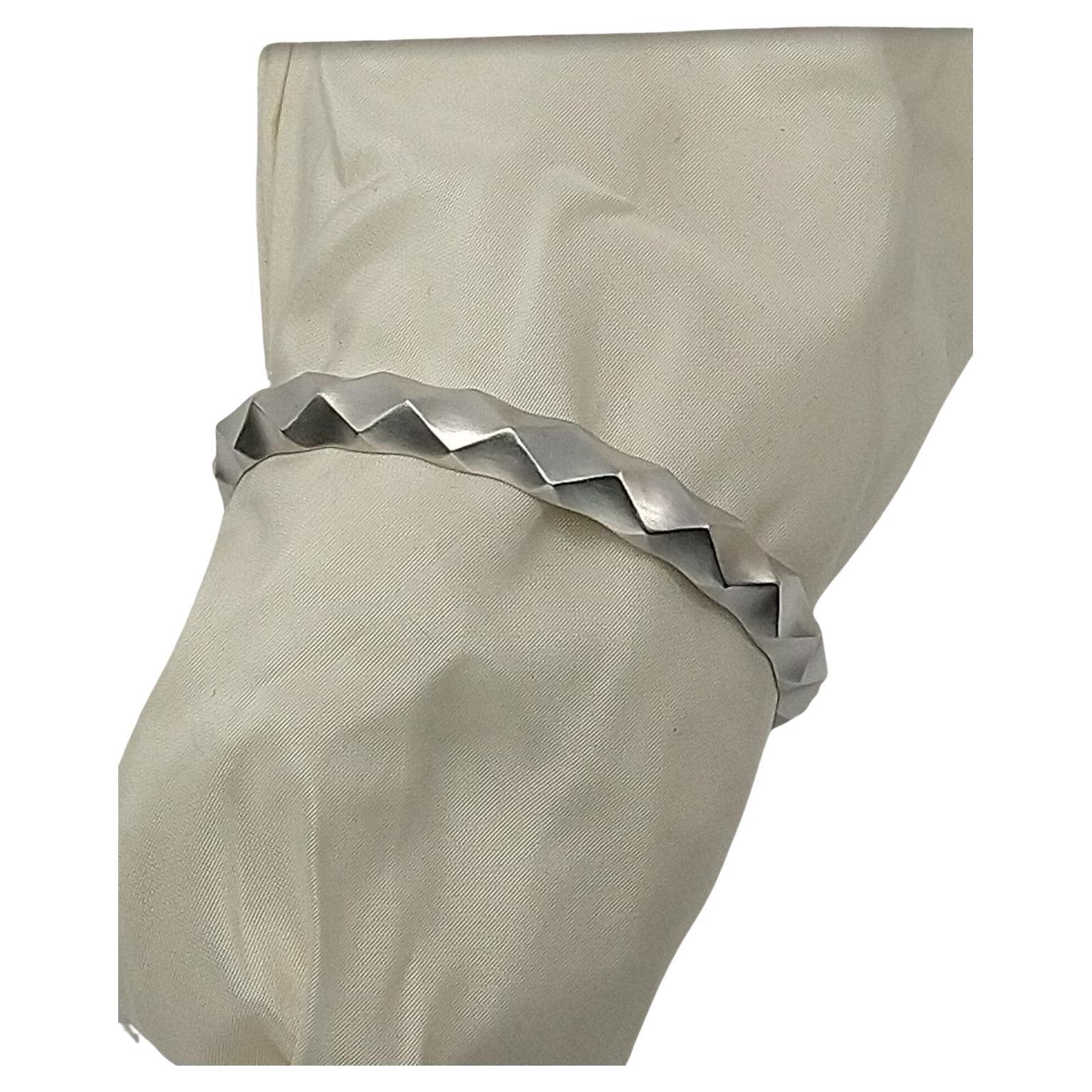Tiffany designer, Thomas Kurilla created this cuff to exploit the rhombus shape.. 14 Karat White Gold  Concave Unisex Cuff Rhombus Bracelet.  I wear a cuff bracelet for years.  My cuff is 5.4mm or shy 1/4 inch wide. I like the slim simplicity of the