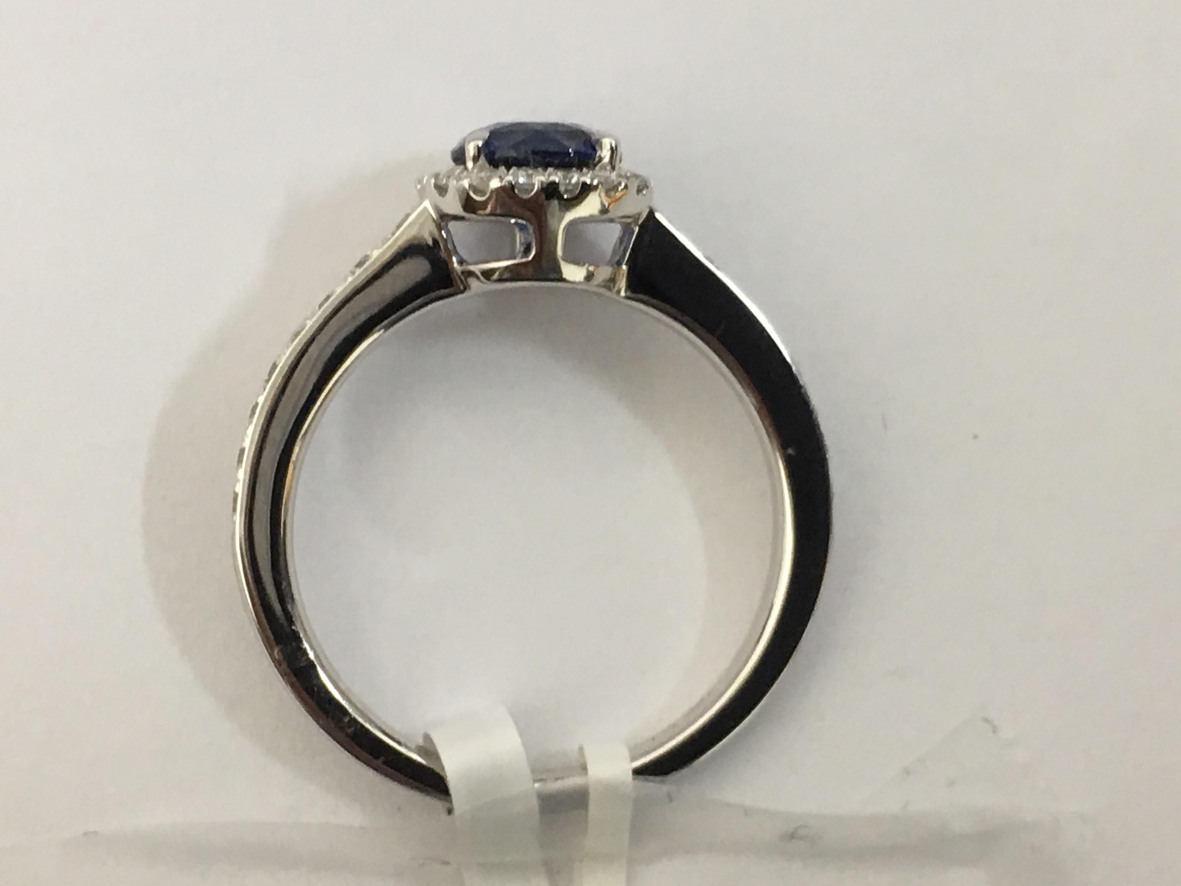 Round Cut Sapphire and Diamond Halo Ring
