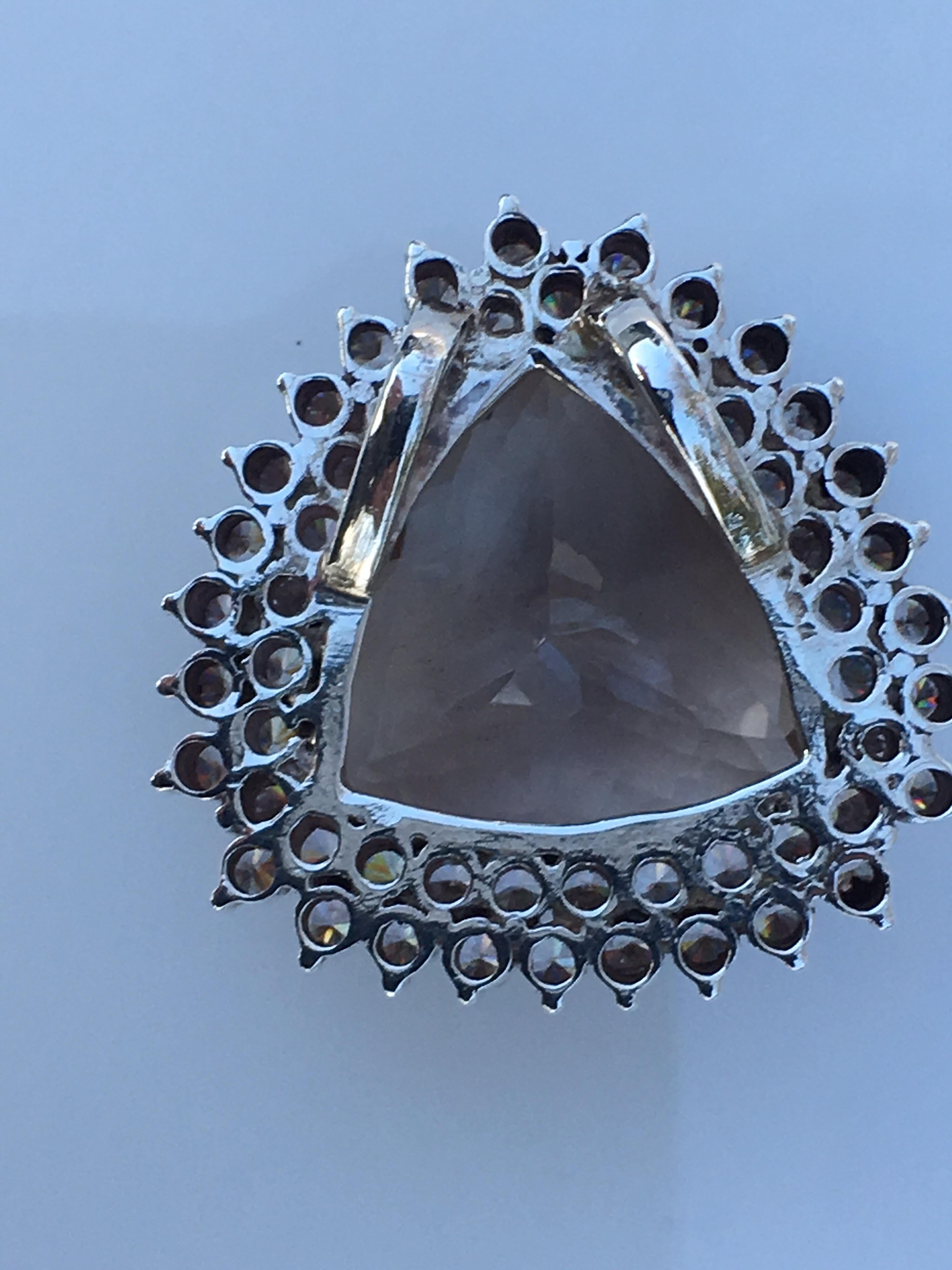 Trillion shape double cut Smokey Quart  with double halo setting Zircon pendant. 
Size of the Smokey Quartz is 21 MM and Size of the pendant is 31 MM
Total weight of the pendant is 21.77 Gram
The pendant 100 % Handmade and one of a kind.
The pendant