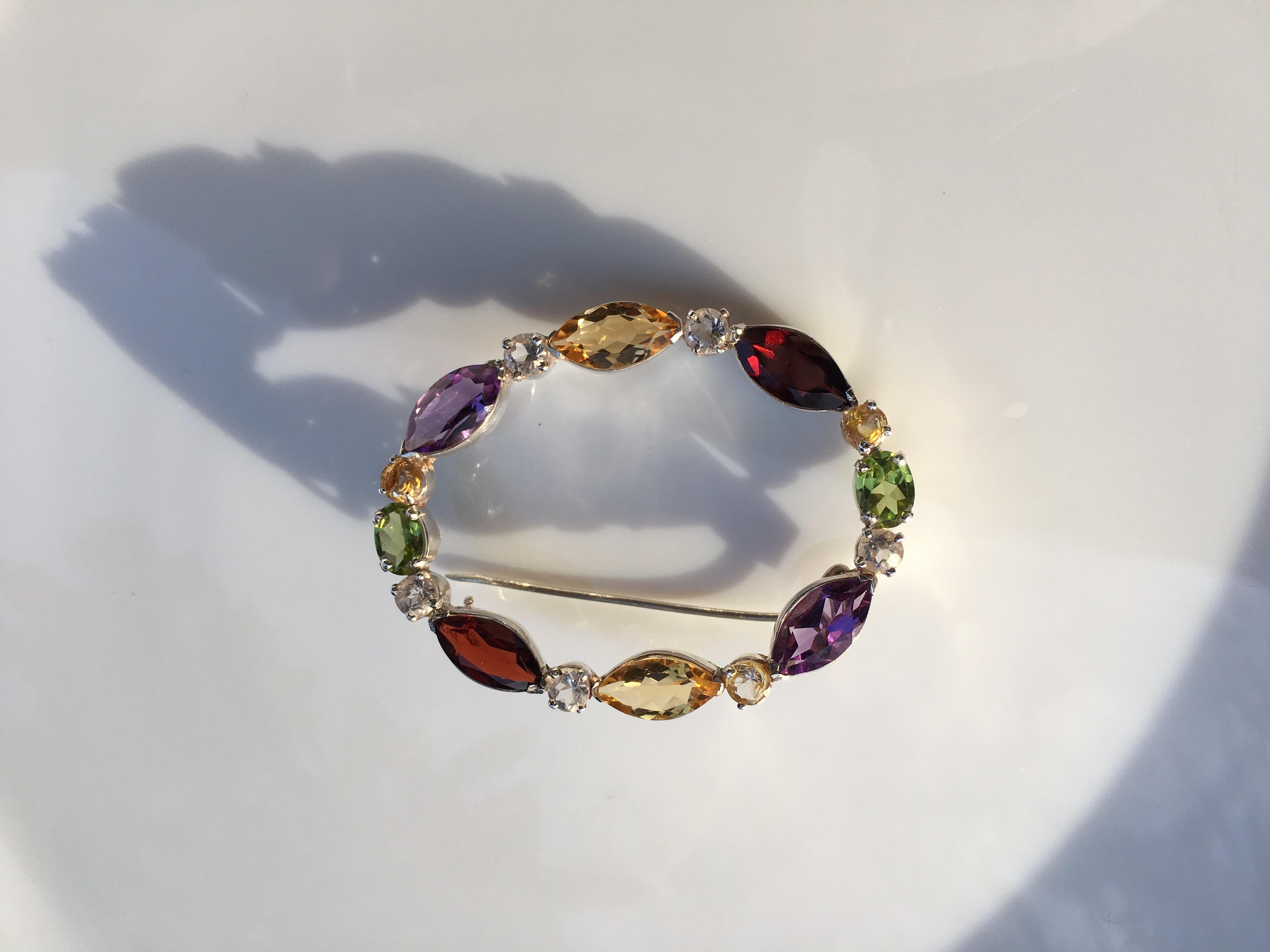Natural Semi precious stones Garnet, Rock crystal, Peridot, Citrine, Ameythest set in sterling silver is handcrafted one of a kind Brooch.Size of Marquise shapes stone are  5 MM x 10 MM , Oval Peridot is 5 MM X 7 MM and All round crystal and Citrine