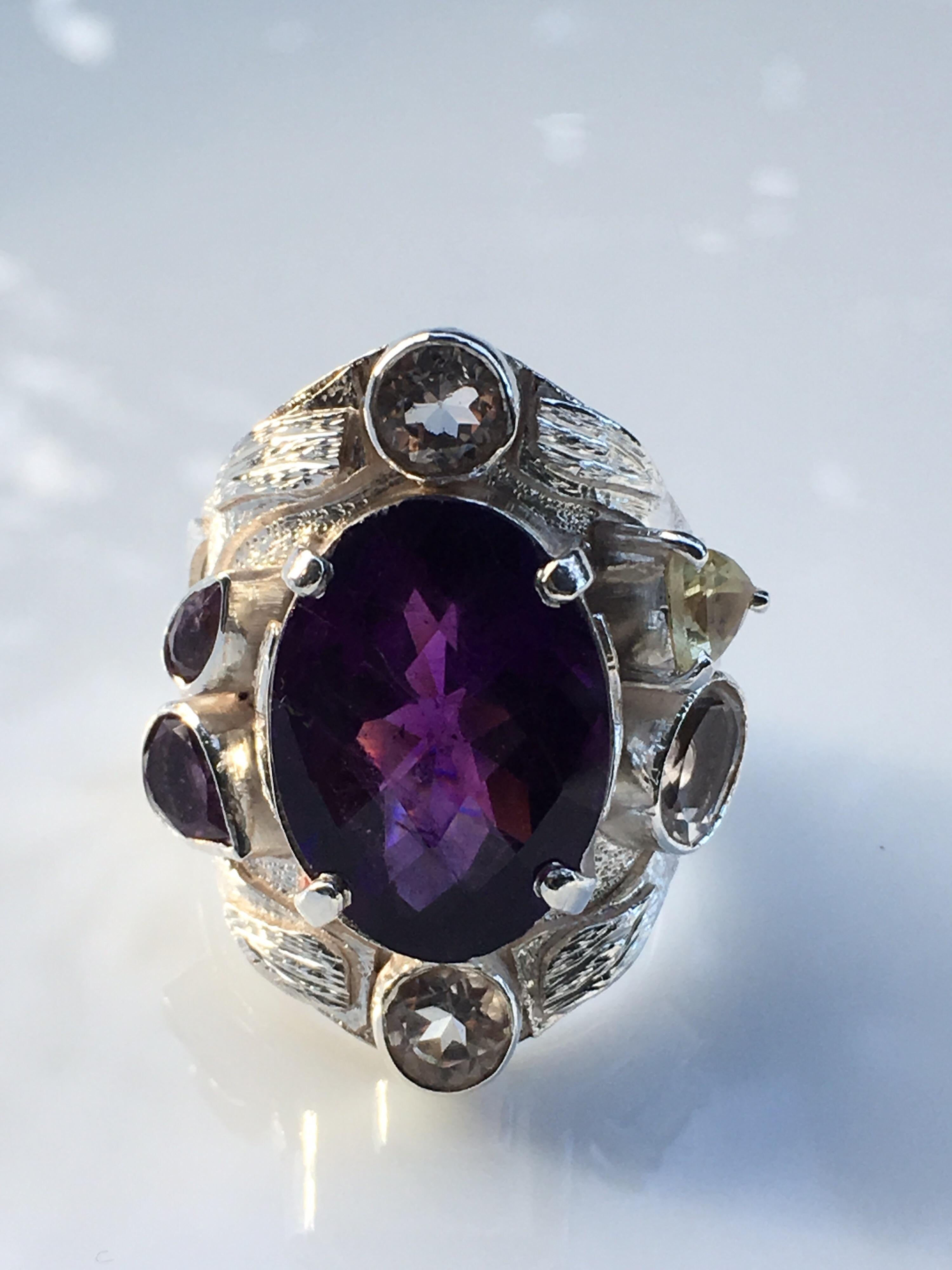 Natural 12 MM X 16 MM Oval double cut Amethyst is one of a kind handcrafted cocktail ring. Other stones are rock crystal Lemon Quartz, and light Amethyst. Ring size is 8 and can be resized. Total weight 16.86 Carat Gram. Approx total stones 14