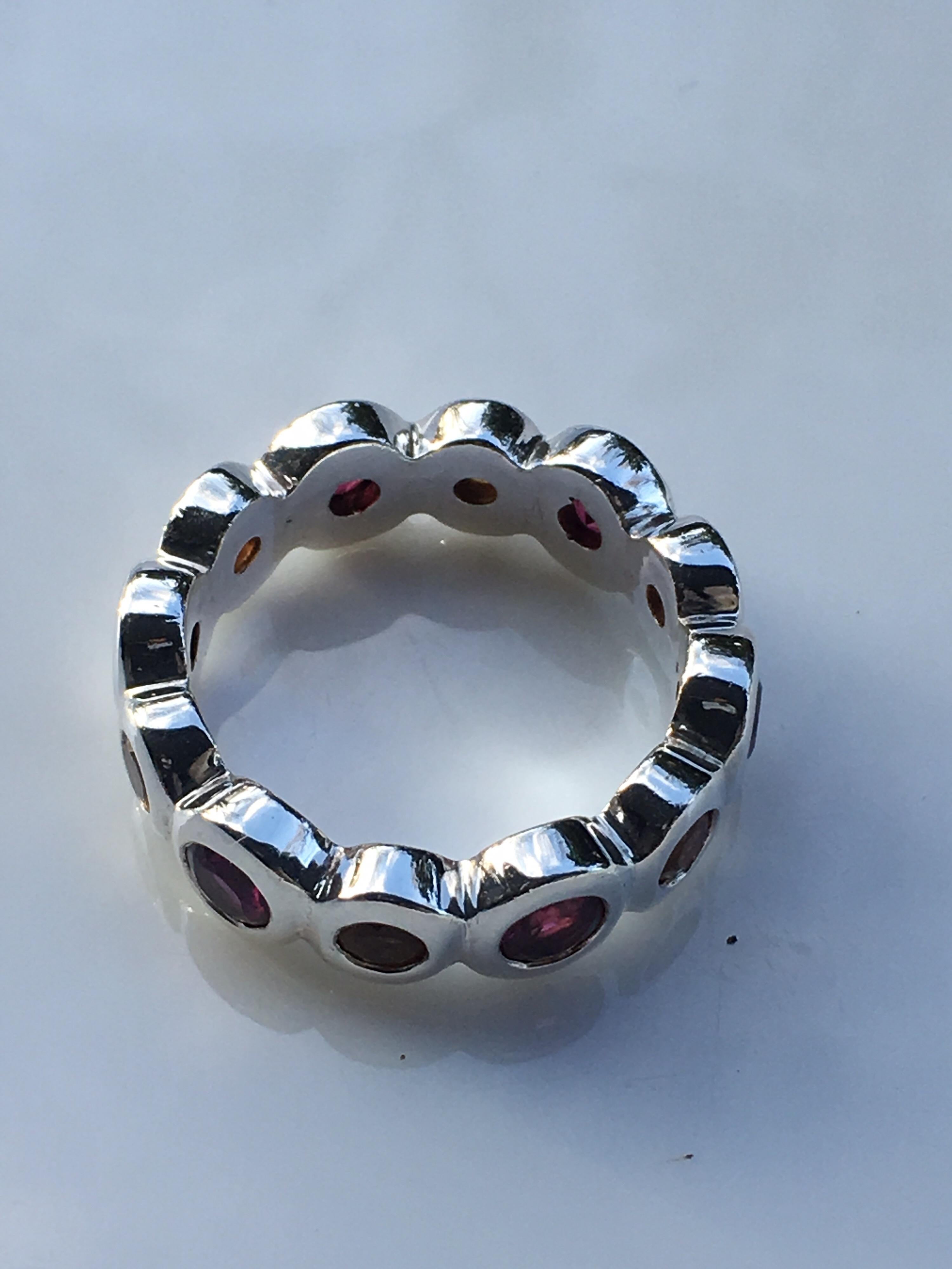 Garnet and citrine 3 MM Round Bazel setting set in sterling silver is hand crafted one of a kind  Eternity Band, 
Size of the Band is 6.5 and this band cannot be resized.Total weight is 6.44 Gram and total stones approx is 1.5 carat.If you are using